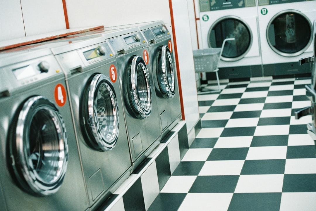 Person washing jeans inside out in a laundry room