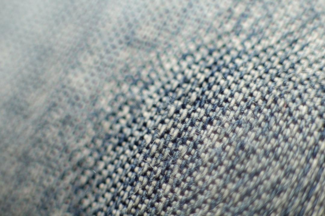 Close-up of blue denim with visible fading and whiskers