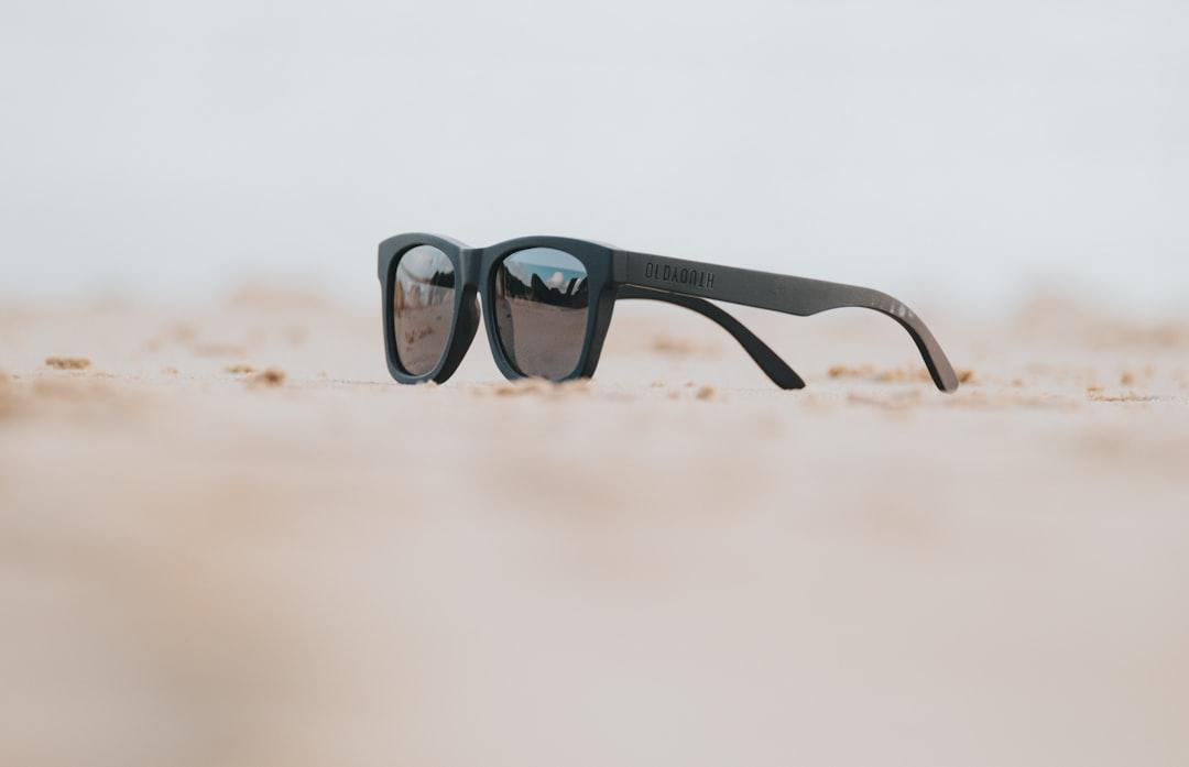 Close-up of black wayfarer sunglasses on a table