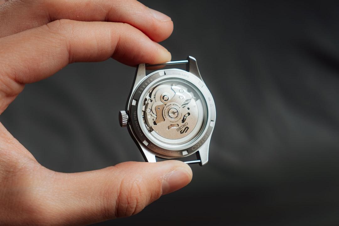 Watchmaker working on a movement in a workshop setting