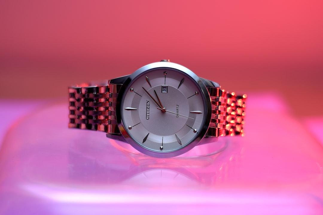 Detailed luxury watch shot on a tabletop with bracelet and dial visible
